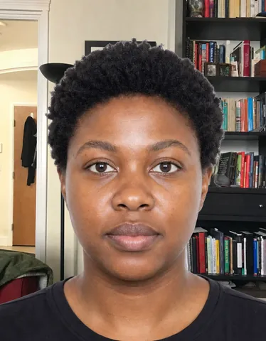 Wrong UK Passport Photo: a busy room is visible behind the person instead of a plain cream background (fictional AI-generated model)